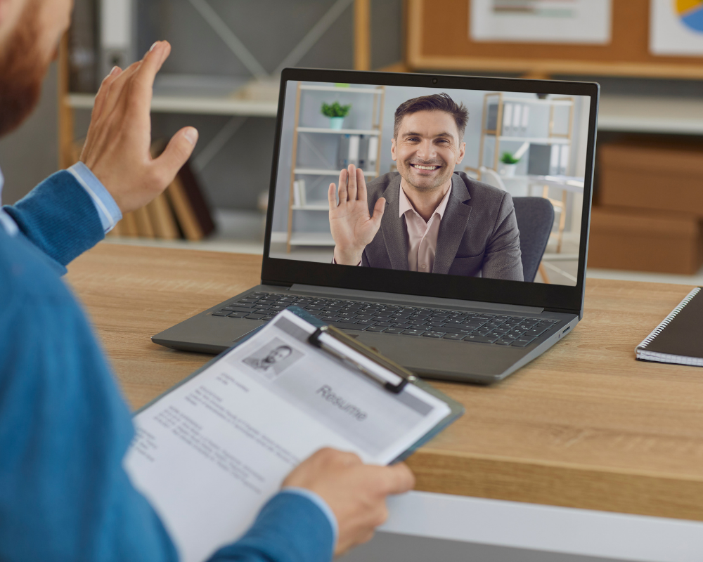 Video interviewers waving to each other