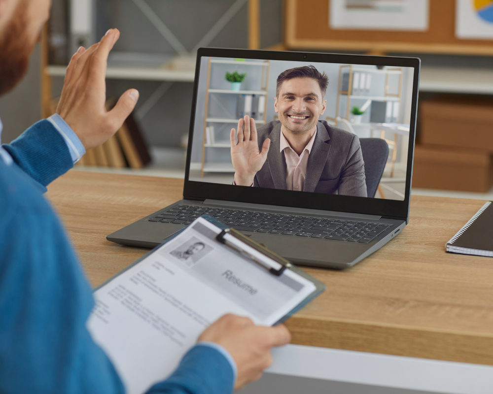 Video interviewers waving to each other 