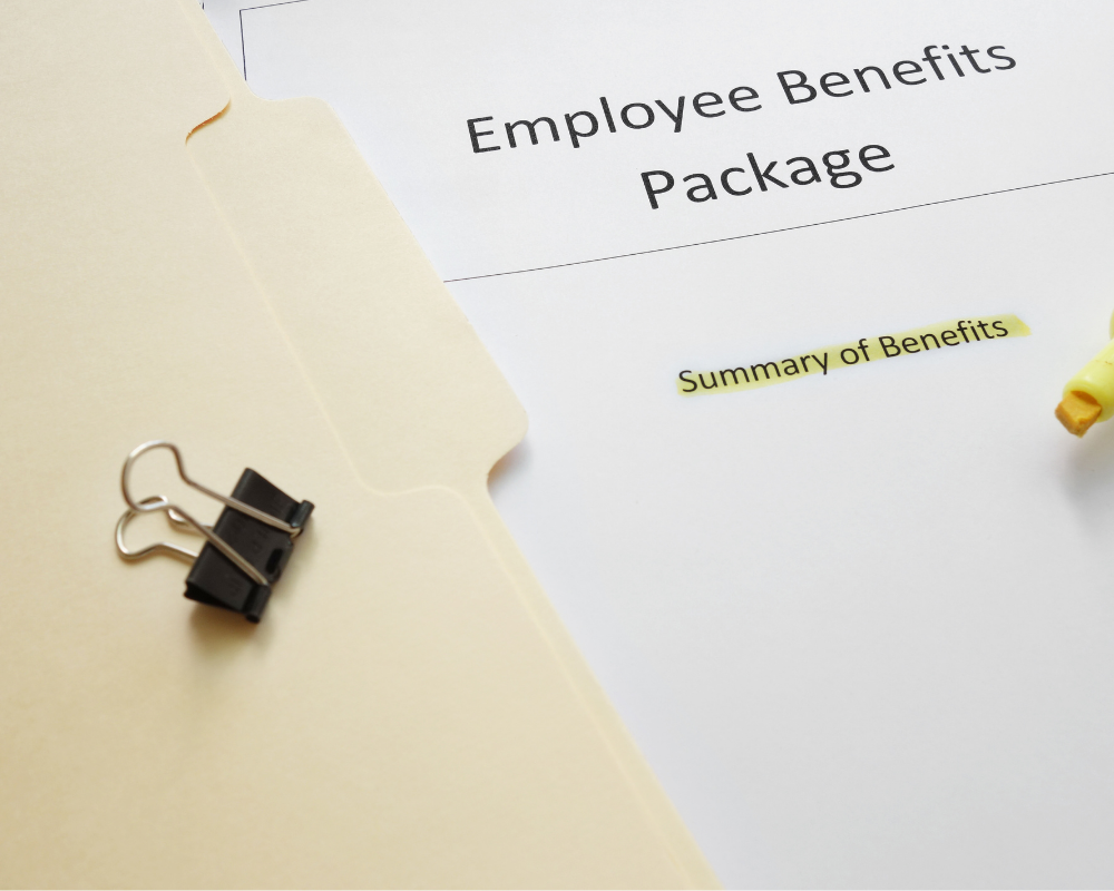 A folder with paperwork for employee benefits.