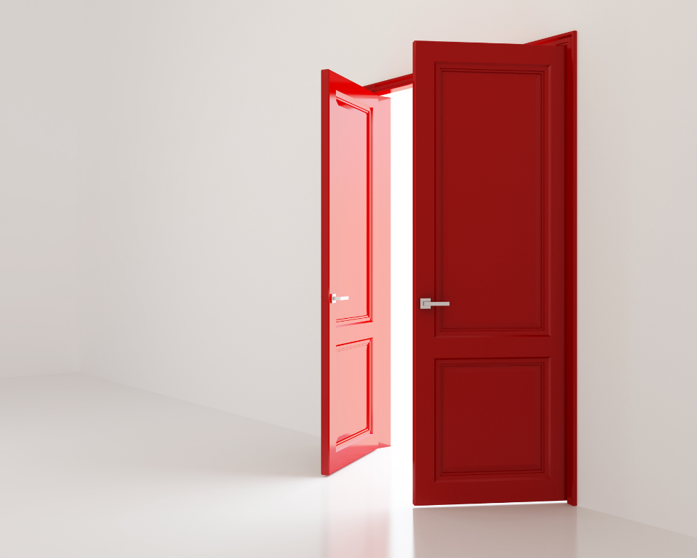 Red door open into white space 