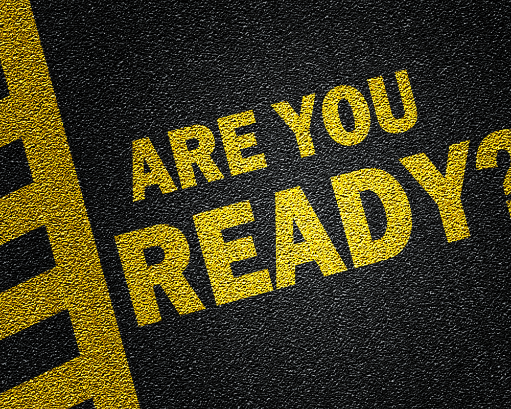 Bold yellow text on asphalt reading ‘Are You Ready?’, creating urgency and motivation for career-driven medical sales professionals.