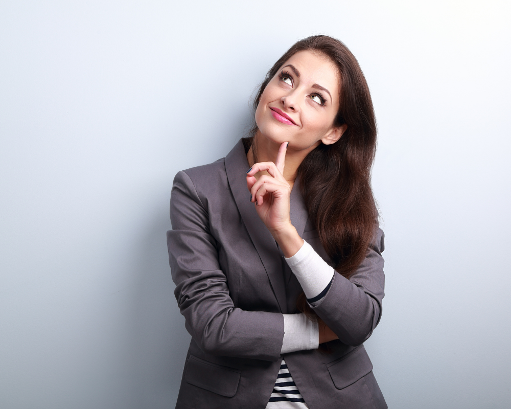 Thoughtful woman in a grey suit considering her career options in MedTech sales