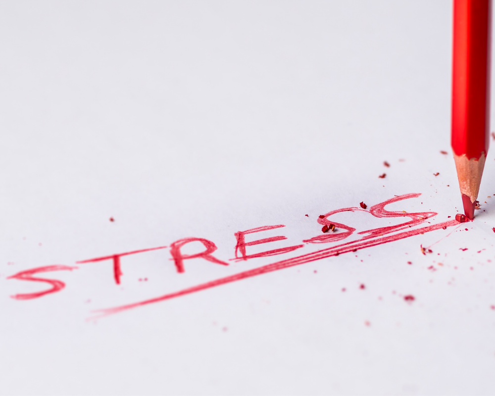 Red pencil writing word stress 