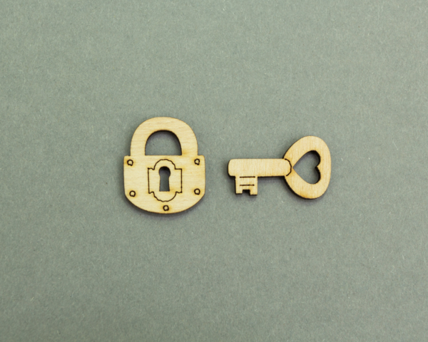Wooden cut lock and key on a grey background.