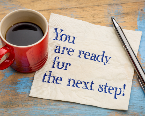 Are you ready for your next step written on a napkin plus a coffee cup and pen