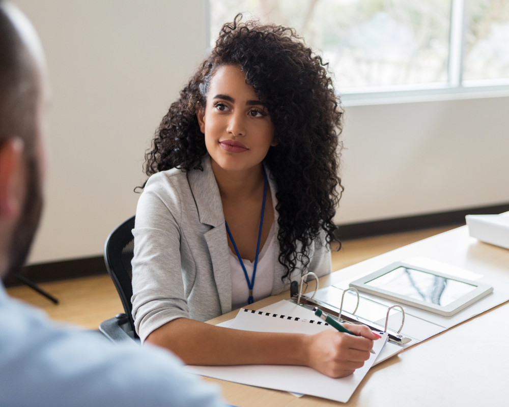 onfident medical sales representative taking notes during a business meeting, demonstrating professionalism and engagement.p
