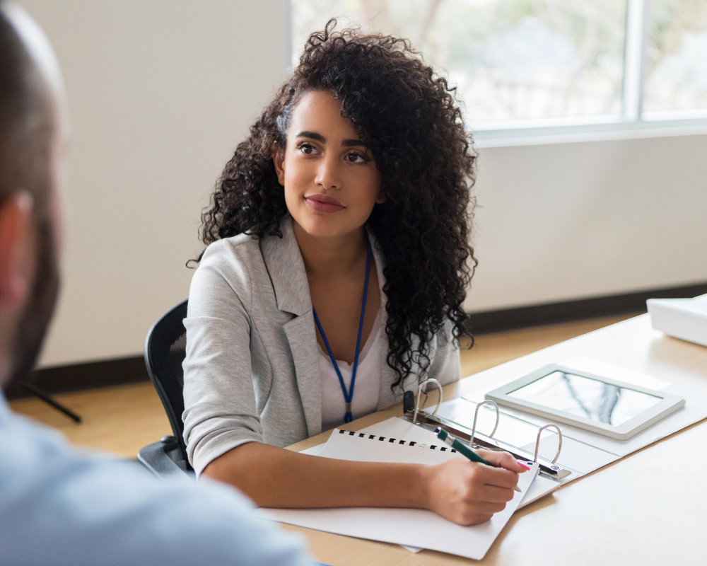 woman in a grey jacket writing notes DukeMed Medical Sales Rep